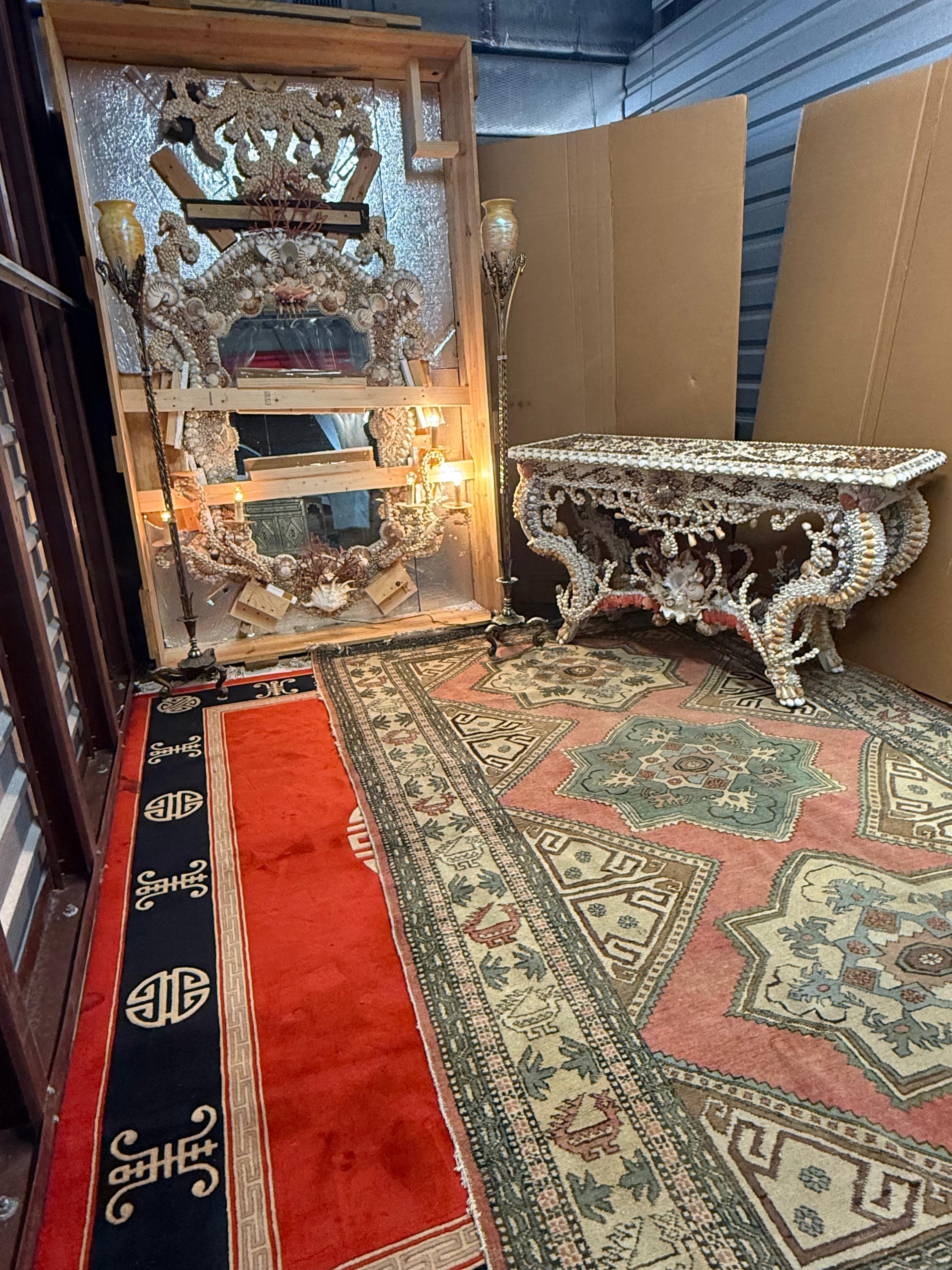 Palm Beach Estate Sale showroom featuring ornate shell mirrors and antique rugs